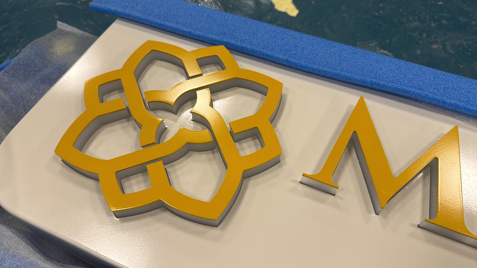 Freshly painted gold Maison Nour emblem and lettering.